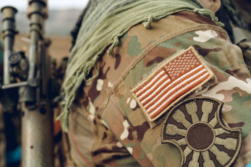 USA flag patch on military uniform of american soldier close up