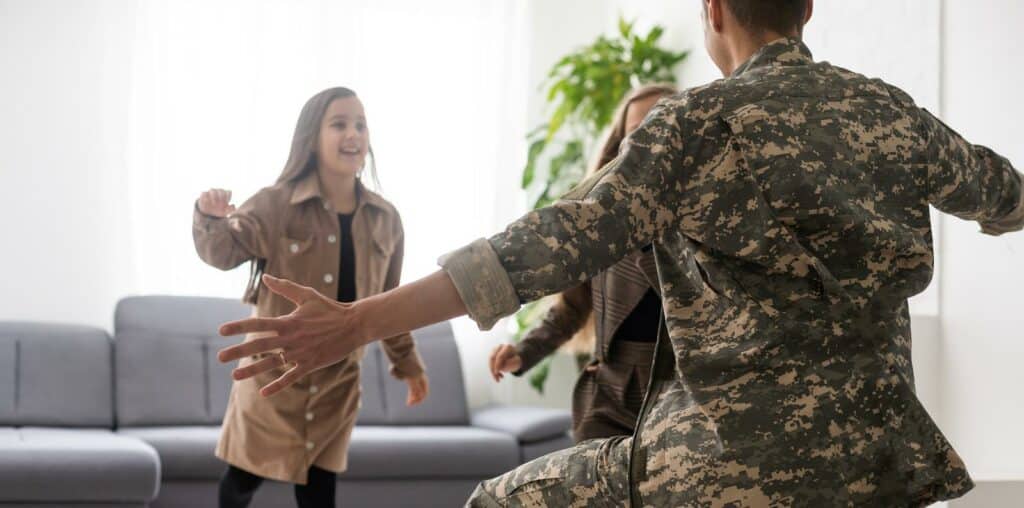 Happy veteran soldier comes back from the military and reunites with family.