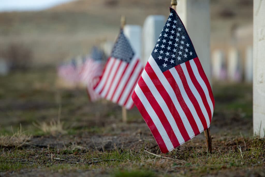 American flag in front of a grave